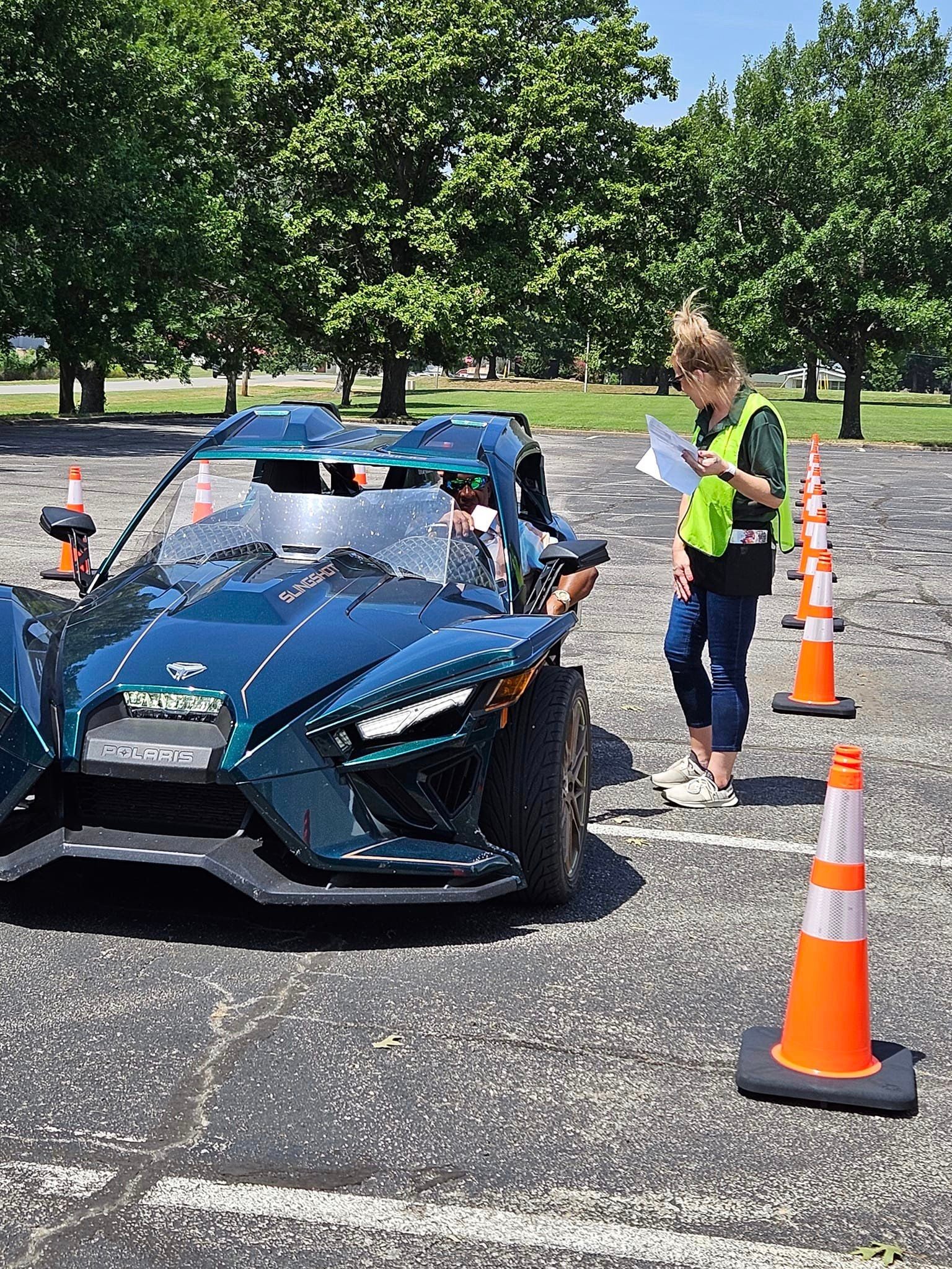A co-op member driving a cool car to the 2023 Annual Meeting.
