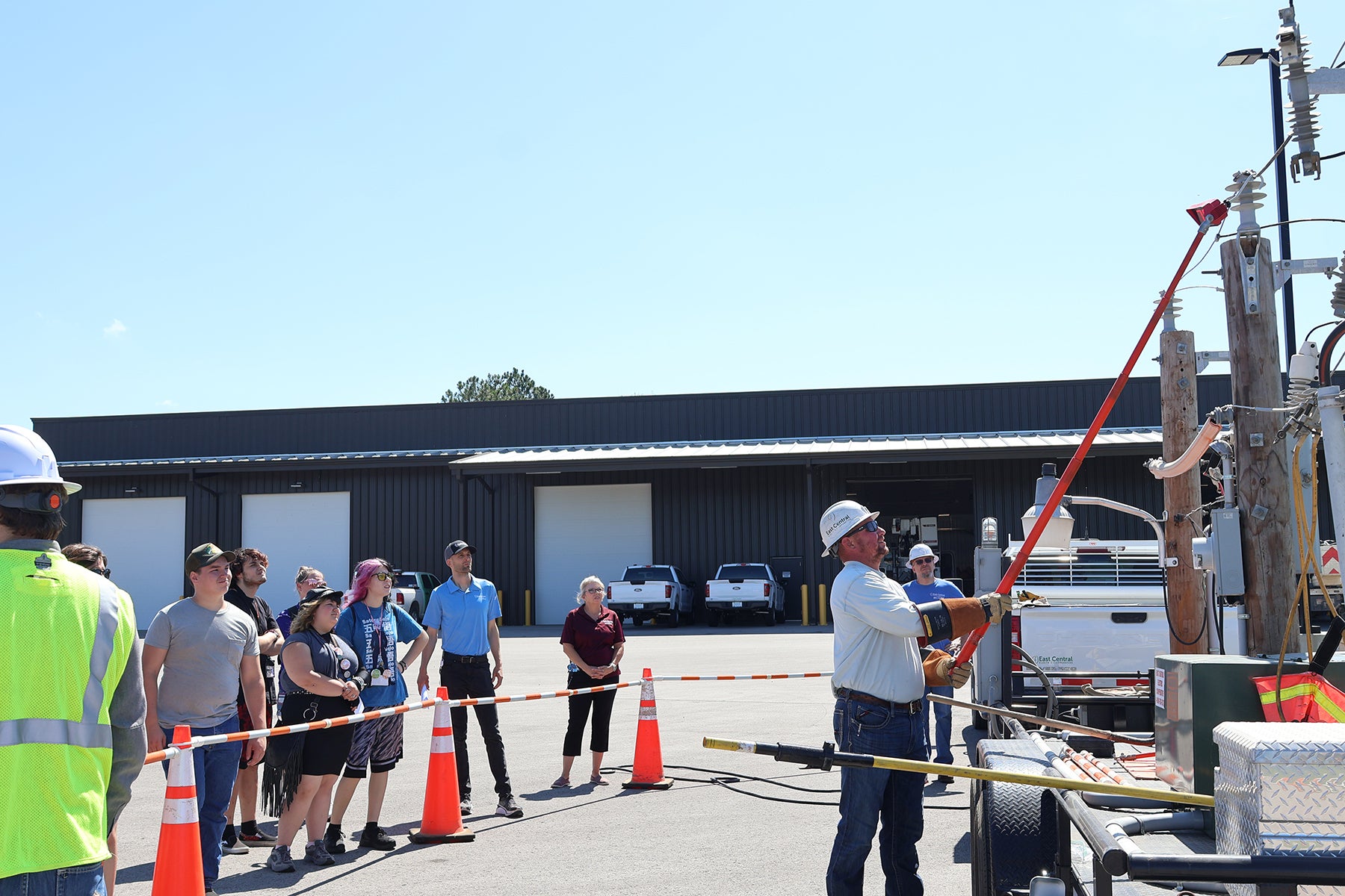 Linemen perform a safety demo for students.