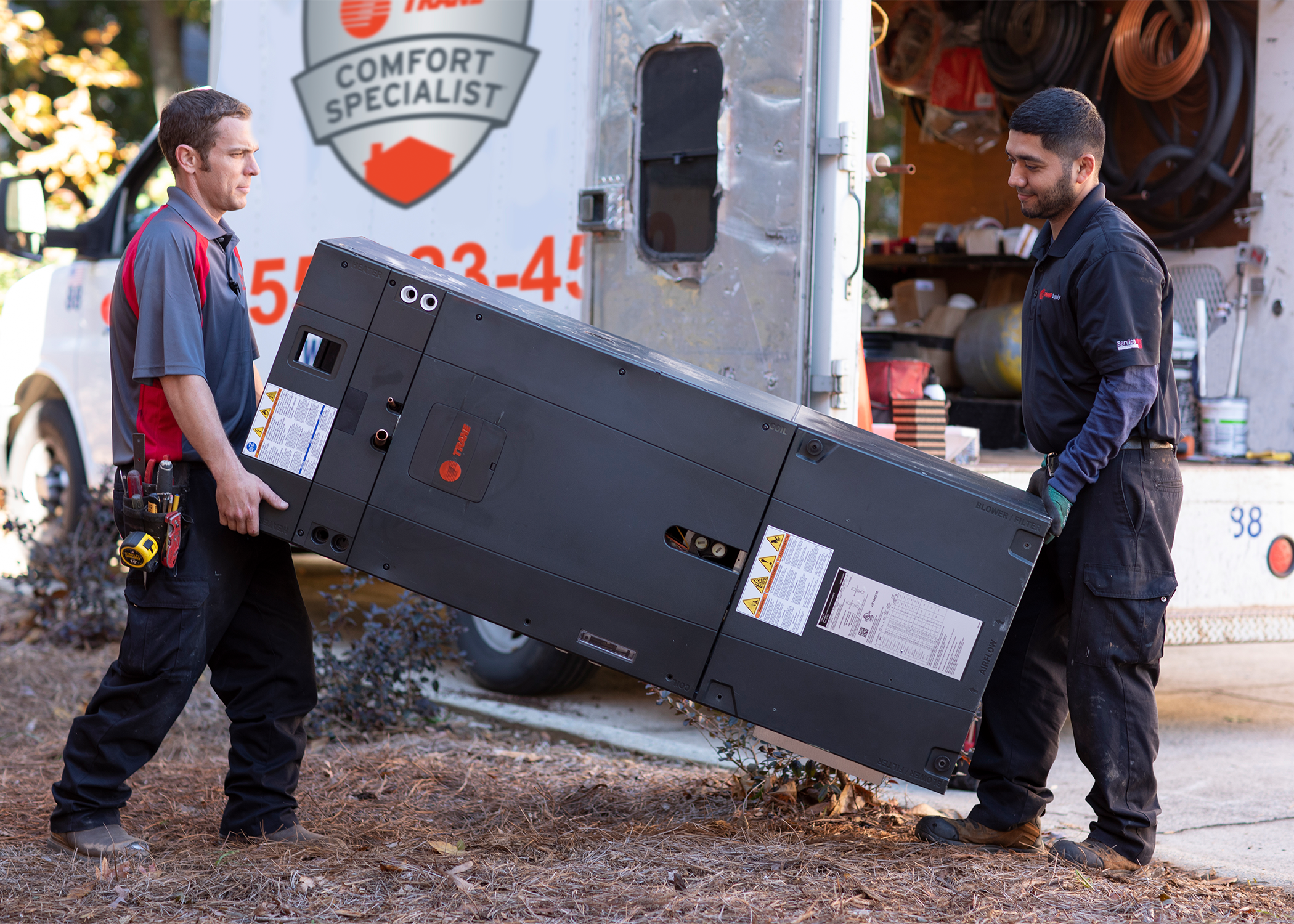 Technician working on an air source heat pump