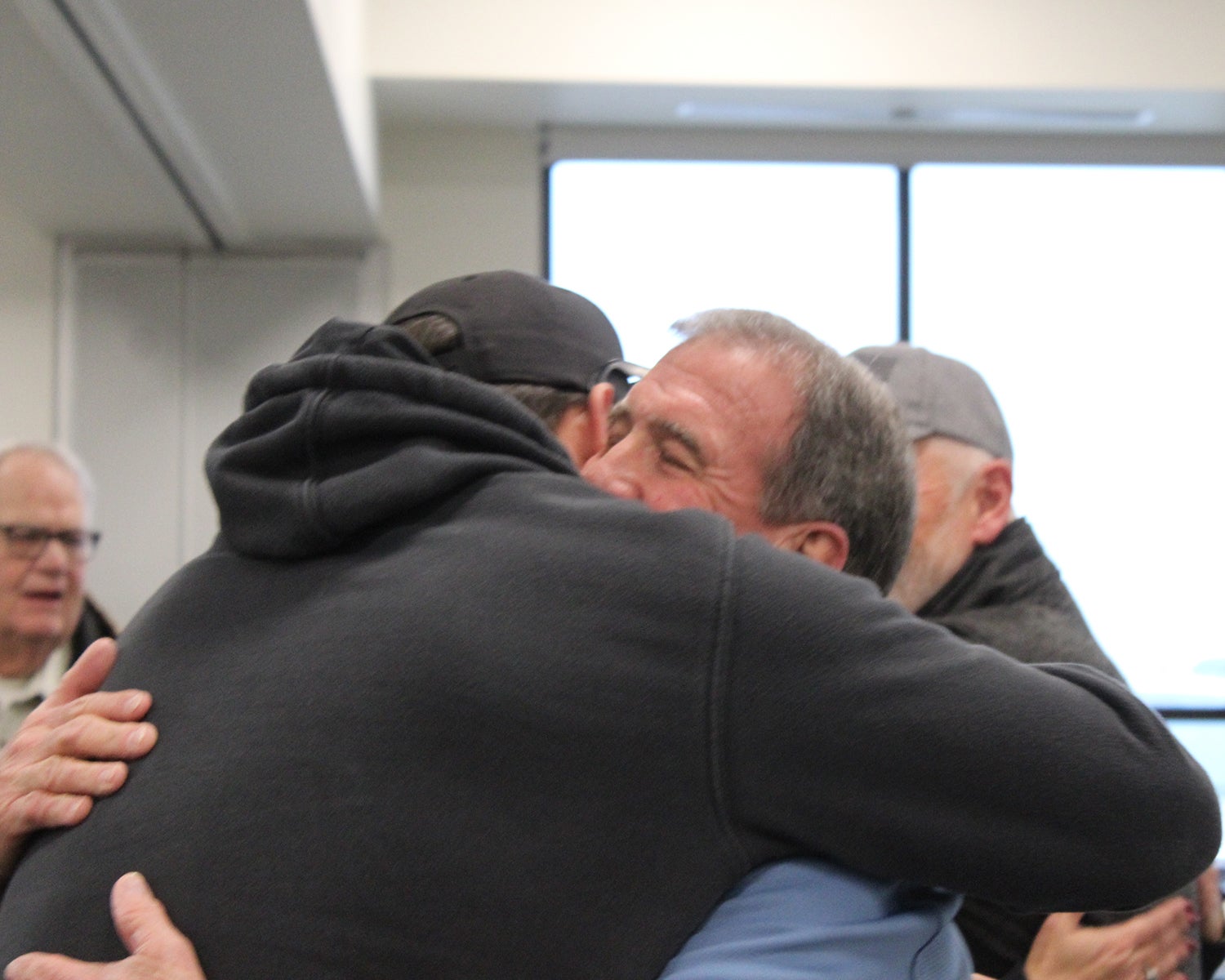 Jack and Bryer hug at Jack's retirement party.