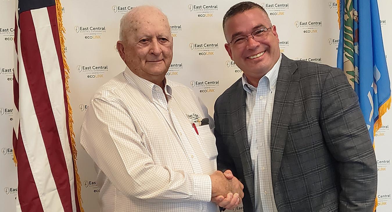 Board President Lowell Hobbs shakes hands with Representative-Elect Chris Banning.